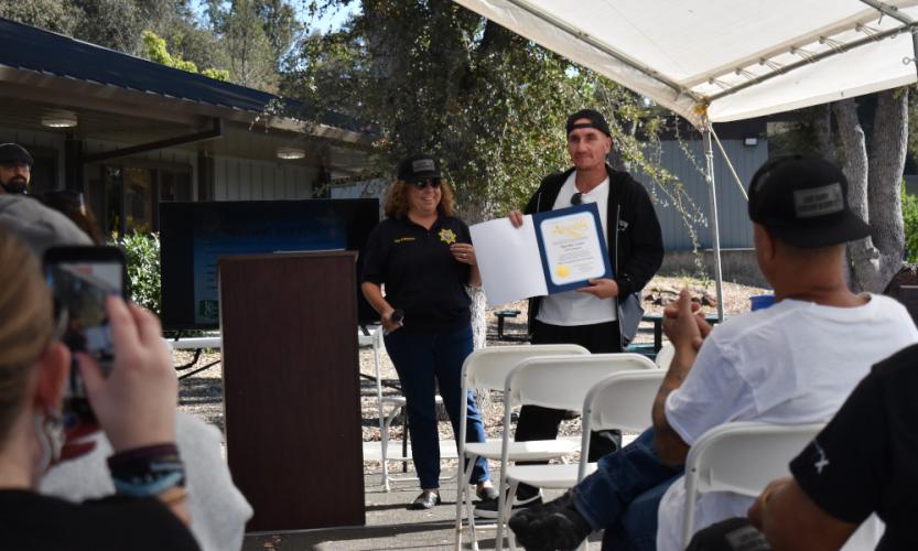 Matthew Larios accepts a certificate for completion of a reentry program from Chief Probation Officer Wendy Mondfrans.
Photo by Albert Chern/Lake County News