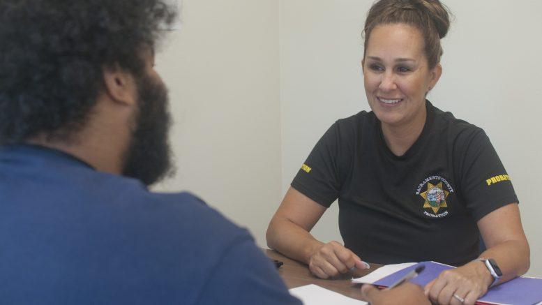 Probation Officer smiling and speaking with a Client