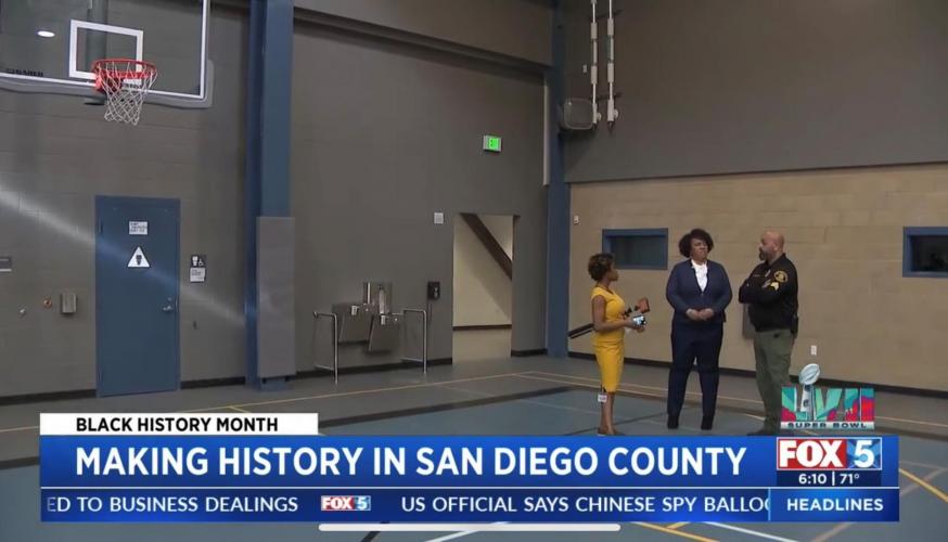 Chief Nelson talks with reporter and staff in Youth Facility basketball court